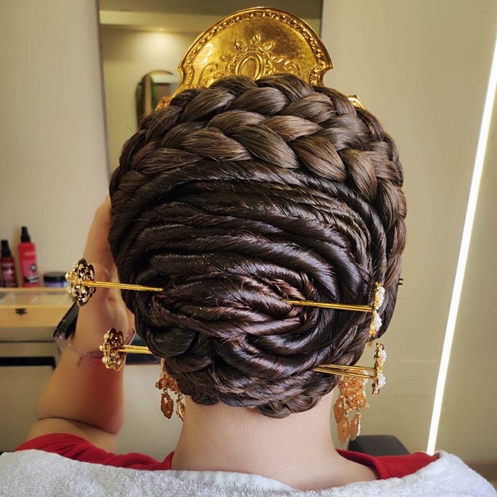 Peinado tradicional fallero con trenzas y complementos dorados